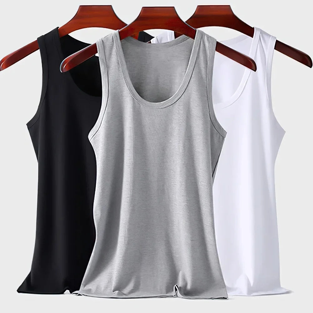 Three men's cotton tank top undershirts in white, breathable sleeveless design, ideal for summer exercise and fitness wear.