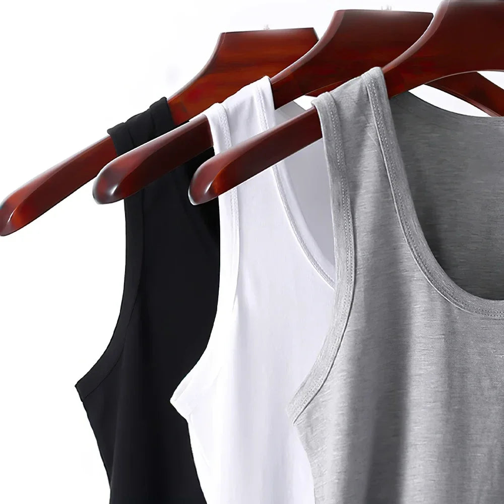 Three men's cotton tank tops by Bernie Chen Store, breathable solid sleeveless undershirts for summer exercise and fitness.